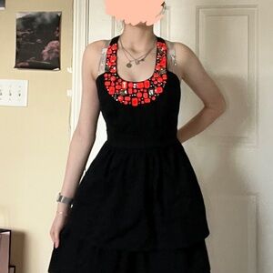 Chic Black Dress with Vibrant Red Details